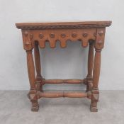 A late 19th century Gothic inspired oak console or side table having a plank top over a single