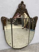 A mid century Art Deco style wall mirror with scrolling foliate cresting above etched and bevelled