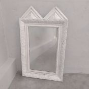 A vintage white painted wall mirror with double pitched pediment over the rectangular plate in a