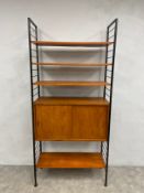 A mid-century teak and metal Ladderax modular shelving unit with four shelves and a cabinet by