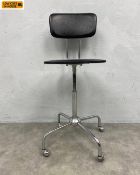 A mid-century swivel desk chair with faux black leather back and seat and narrow height adjustable