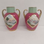 A pair of early 20th century porcelain vases each hand painted with scenes of ruins in Continental