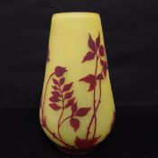 An early to mid 20th century studio overlay glass vase with oxblood red foliate and floral