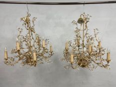 A pair of 19th century French wrought and painted metal chandeliers each with allover scrolling
