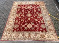 A large Afghan Zeigler carpet with allover scrolling foliate over an abrash red ground within a