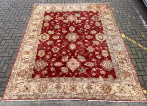 A large Afghan Zeigler carpet with allover scrolling foliate over an abrash red ground within a