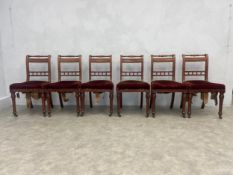 A set of six late 19th century walnut bar back dining chairs on tapering fluted supports terminating