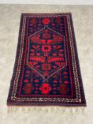 A Turkish Anatolian Yagcibedir village style rug with central stepped box red diamond lozenge