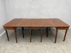 A large 19th century figured mahogany extending dining table in three parts comprised of two d-