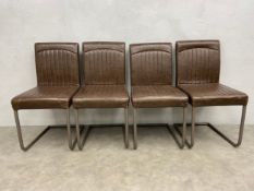A set of four retro styled dining chairs on cantilever metal bases in faux leather upholstery. H.
