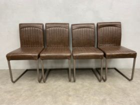 A set of four retro styled dining chairs on cantilever metal bases in faux leather upholstery. H.
