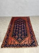 A 20th century hand knotted Persian carpet with five rows of pole medallions in a stepped diamond
