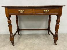 A 19th century walnut writing table with inset leather top on turned stretchered supports. H.74 W.95