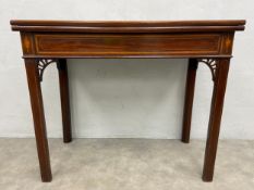 A Georgian mahogany card table with satinwood crossbanded and urn inlaid top with gateleg action.