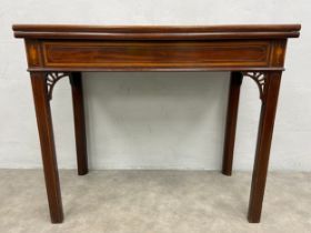 A Georgian mahogany card table with satinwood crossbanded and urn inlaid top with gateleg action.