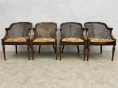 A set of four early 20th century mahogany Bergere tub armchairs each having a shaped cane back, seat