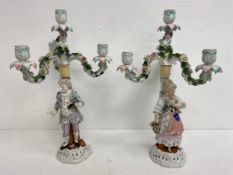 A pair of 19th century three branch Sitzendorf candelabras with flowerhead decoration and figural