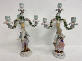 A pair of 19th century three branch Sitzendorf candelabras with flowerhead decoration and figural