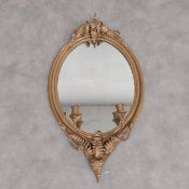 A 19th century giltwood and gesso girandole wall mirror with fern leaf cresting above oval plate and