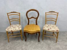 A pair of 19th century beech side chairs with ribbon carved cresting and a Continental 19th