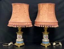 A pair of 19th century French Sevres style brass mounted porcelain table lamps each with pierced