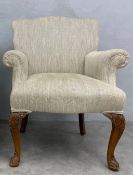 An early 20th century George I style armchair reupholstered in herringbone Andrew Martin fabric on