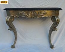 A vintage Rococo style console table with black painted serpentine top and gilt shell frieze
