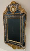 A contemporary Venetian style wall mirror with gilt cresting and engraved plate. 140 x 65cm