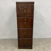 An early 20th century Oak Union style office filing cabinet with four drawers raised on a square