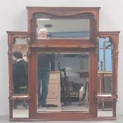 A C.1900 walnut overmantel mirror having an arrangement of four mirrors set into a carved and shaped