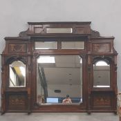 A Edwardian rosewood overmantel mirror with an arrangement of six bevelled mirrors set into an