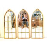 A set of three Gothic style gilt metal arched plate architectural wall mirrors. 102x40cm.