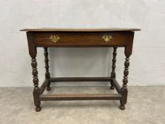 A 19th century oak side table with thumb-moulded plank top over a single frieze drawer raised on