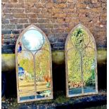 A pair of metal framed mirrors of arched Gothic form. 122x56cm.