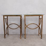 A pair of contemporary Art Deco style side tables each having a plate glass top raised on a