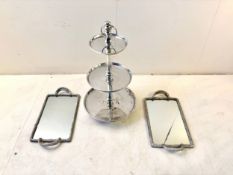 A vintage three tiered chrome cake stand together with a pair of mirrored trays in faux rope
