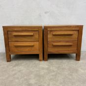 A pair of contemporary teak bedside cabinets each with a square top over two drawers raised on