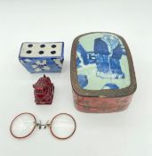 A mixed lot to include a Chinese red lacquered box with blue and white porcelain top, a composite