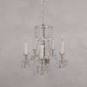 A 20th century Bohemian style cut glass five branch chandelier with electric faux candle light