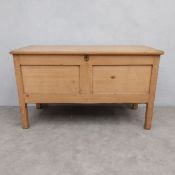 A C.1900 pine blanket chest or trunk with hinged plank top enclosing the interior with fitted candle