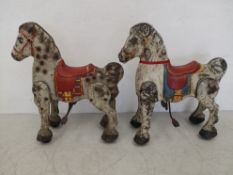 Two 1950s hand painted tin Mobo bronco horses with dapple grey finishes. H.75 W.67cm
