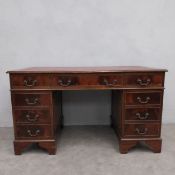 A Georgian style mahogany three section pedestal desk with a gilt tooled leather inset top. H.78 W.