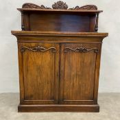 A 19th century rosewood chiffonier sideboard having a carved superstructure over two figured panel