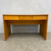 A vintage mid-century style teak desk with sliding plank top enclosing a secret compartment over
