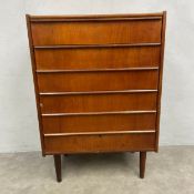 A mid-century Danish style teak chest of six graduating drawers raised on tapered circular section