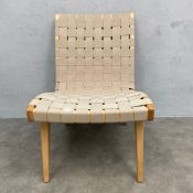 A contemporary lounge or accent chair with woven nylon webbed back and seat over a shaped maple