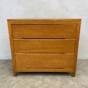 A mid-century oak chest of three long drawers raised on straight stile supports. H.8o W.87 D.49cm.