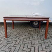 A Chinese huanghuali extending dining table having a rectangular panel top with an additional leaf