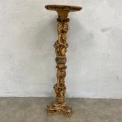 A vintage Eastern style composite resin pedestal stand with engraved flowerhead top raised on a cast