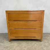 A mid-century oak chest of three long drawers raised on straight stile supports. H.80 W.87 D.49cm.